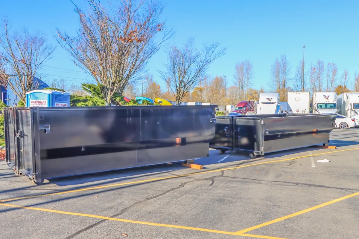 Professional dumpster rental service with roll-off container on residential driveway in New Fairfield